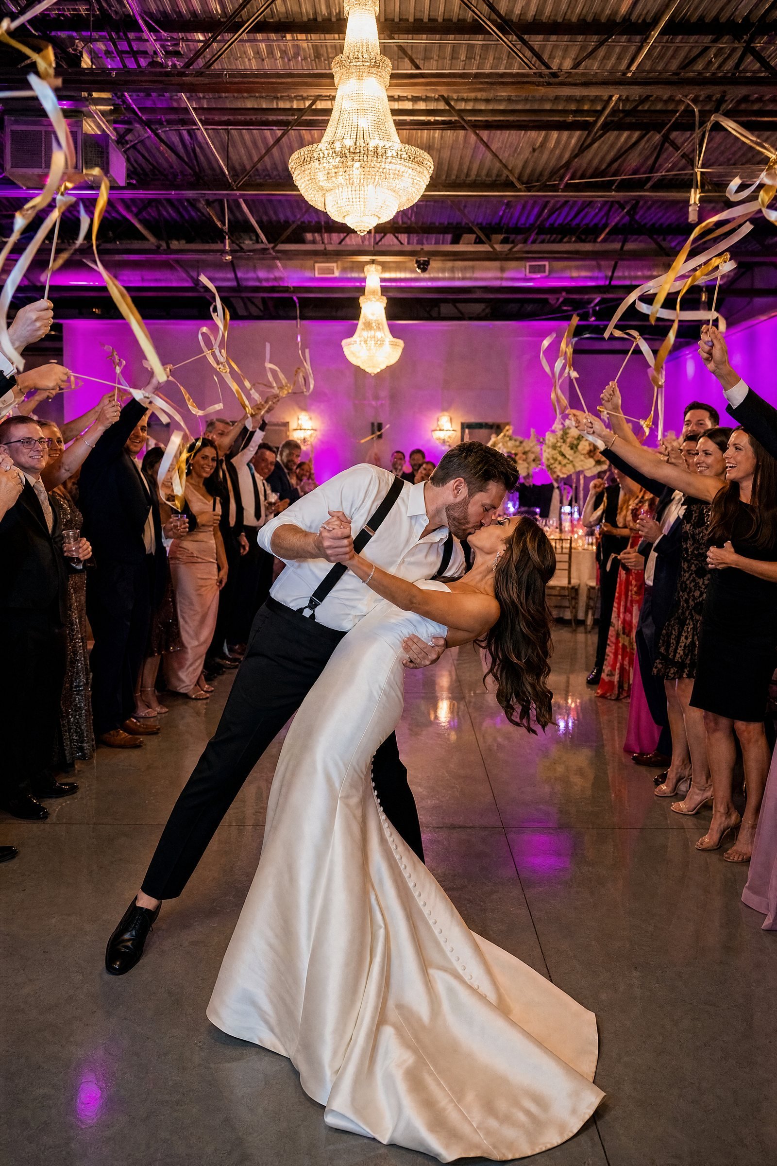 Couple dancing under the chandeliers in The Dome at The Hendrix while guests cheer, Stafford, Houston