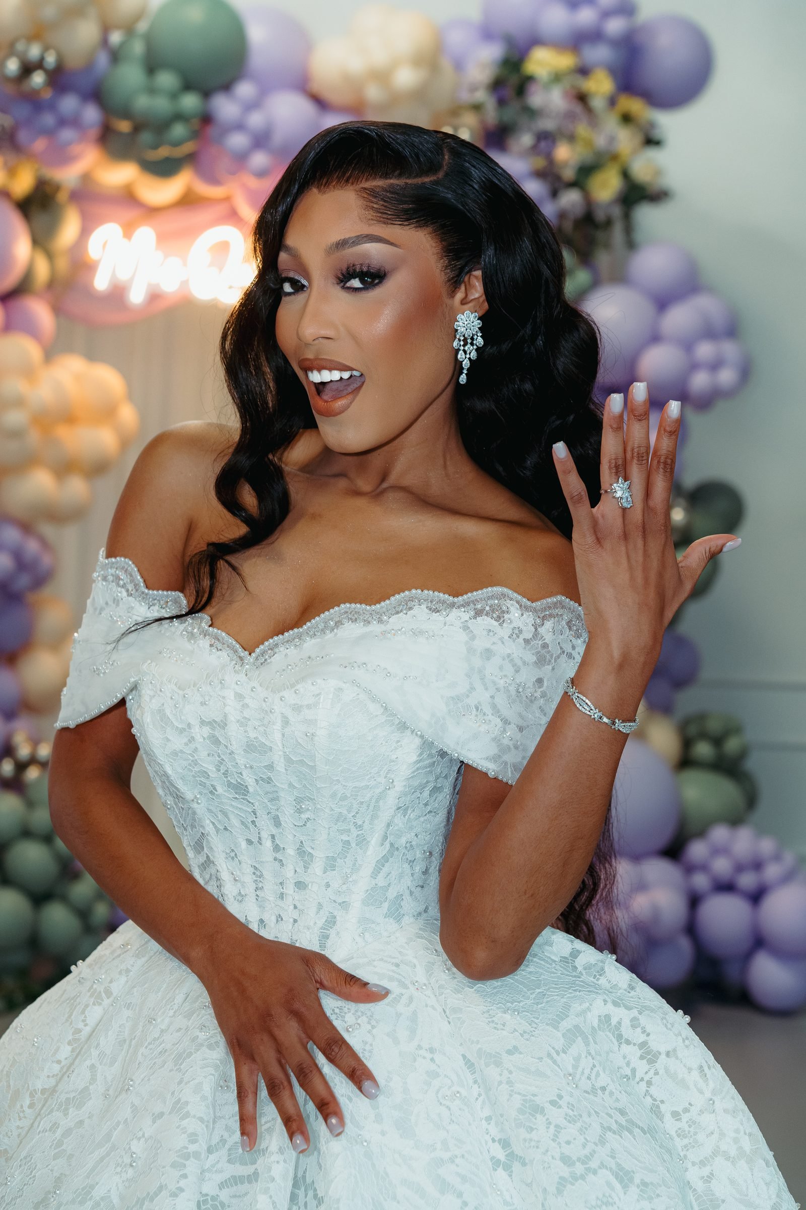 Guest in a pale blue gown in front of a pastel balloon installation in The Mansion at The Hendrix