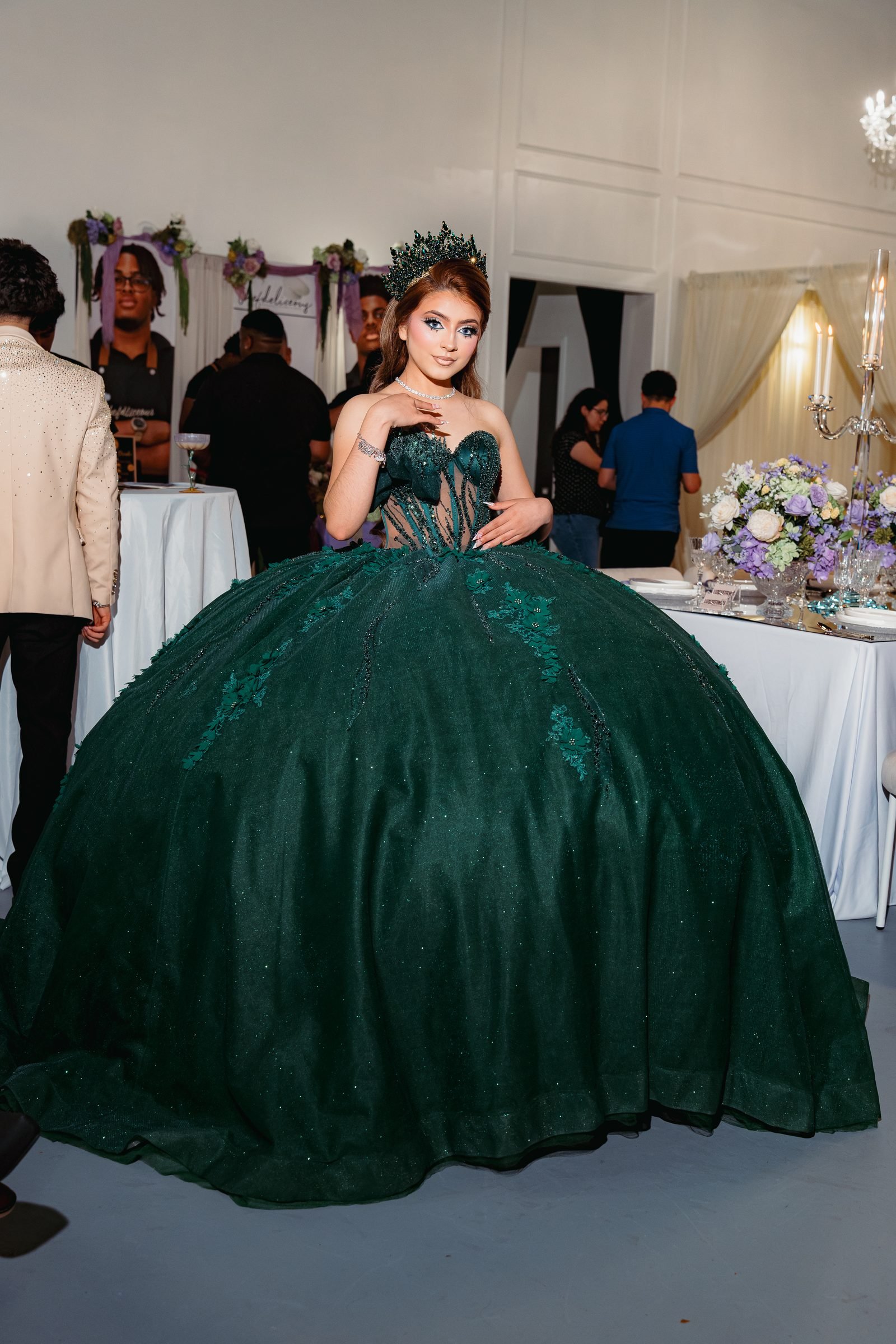 Quinceañera in an emerald ballgown at her celebration in The Mansion at The Hendrix, Stafford