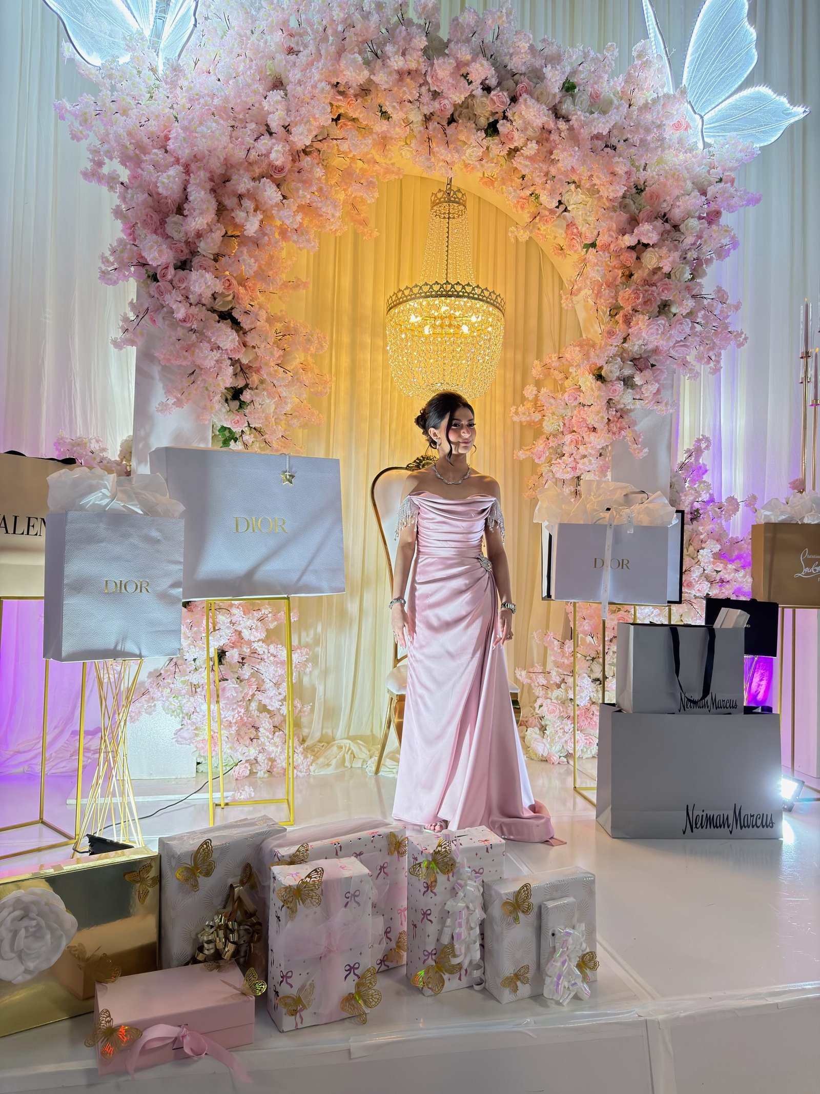 Pink blossom arch and gift display at a quinceañera celebration at The Hendrix in Stafford, Houston