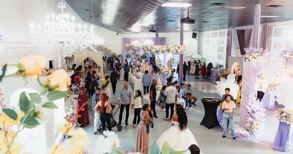 Guests filling the Mansion at The Hendrix in Stafford under crystal chandeliers, ten minutes from Sugar Land and Missouri City