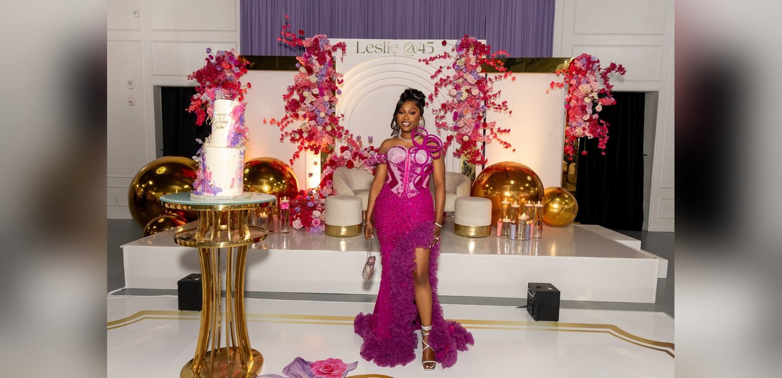 A tiered cake, blossom trees and gold orb staging set for a Nigerian celebration in The Mansion at The Hendrix