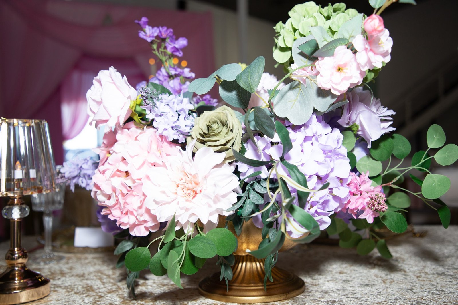 A blush, lilac and sage centrepiece in a gold compote at Dear Mama, The Hendrix