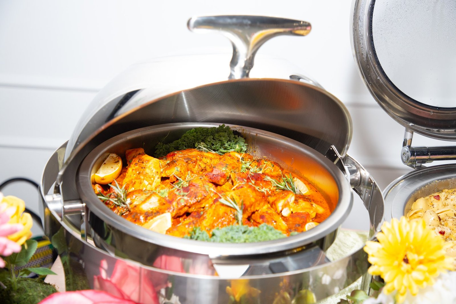 A chafing dish of stewed chicken garnished with herbs at Dear Mama, The Hendrix