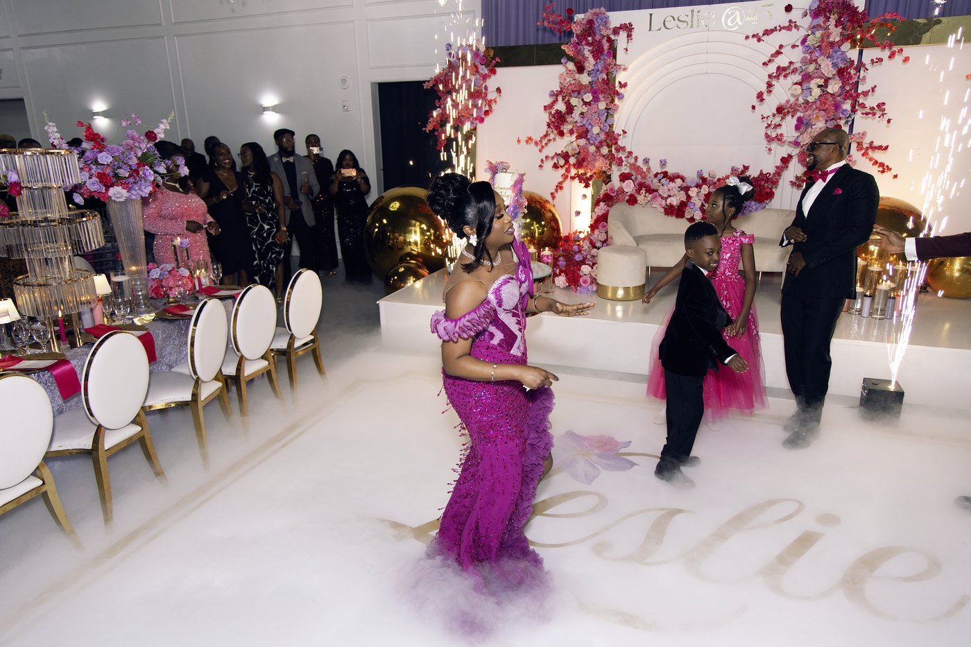 The celebrant dancing up the aisle through dry ice at her Nigerian 45th birthday at The Hendrix