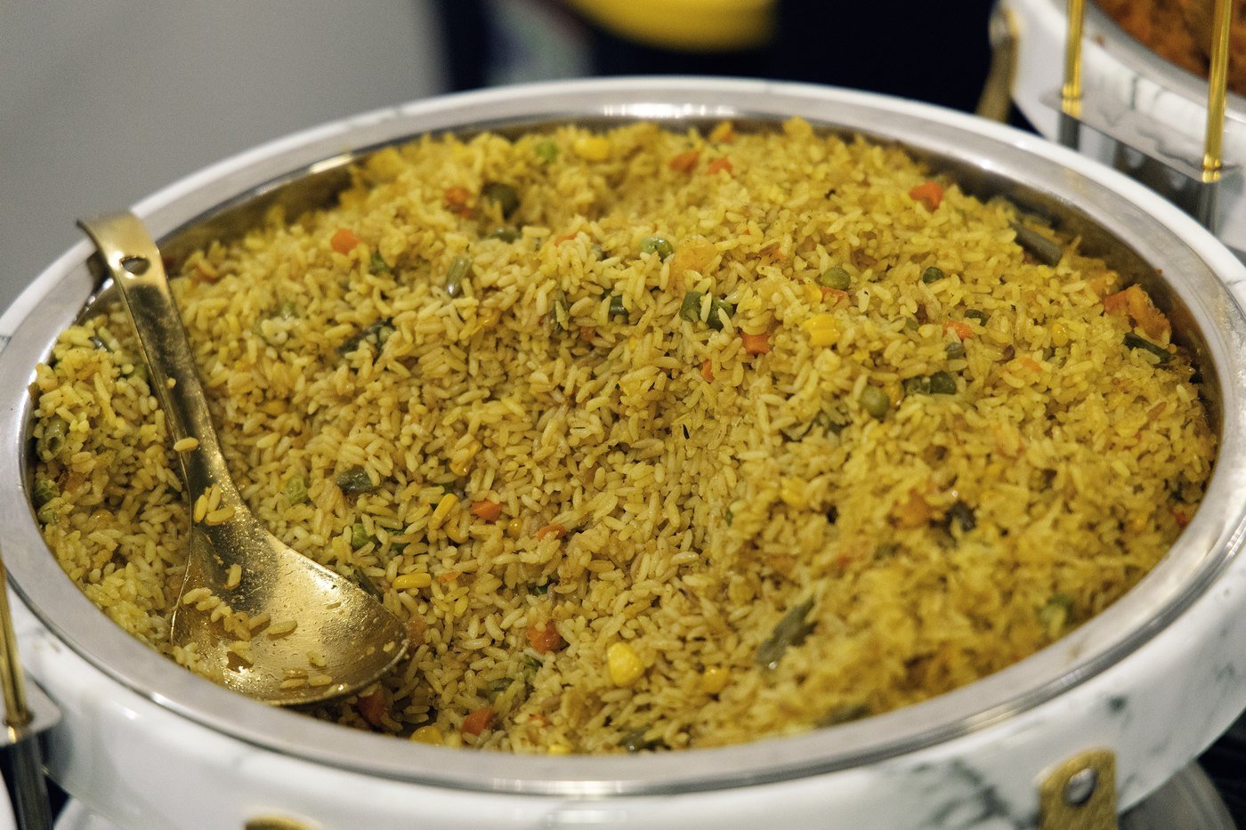 Party jollof rice in a gold serving dish at a Nigerian birthday party at The Hendrix