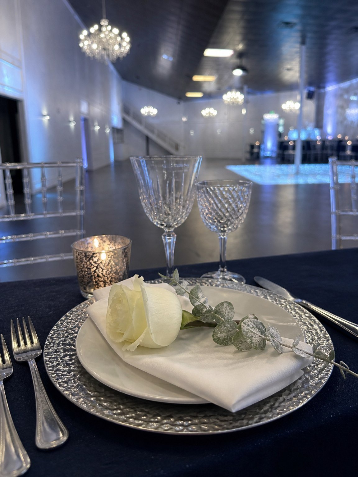 A navy and silver place setting at a Mitzvah dinner at The Hendrix