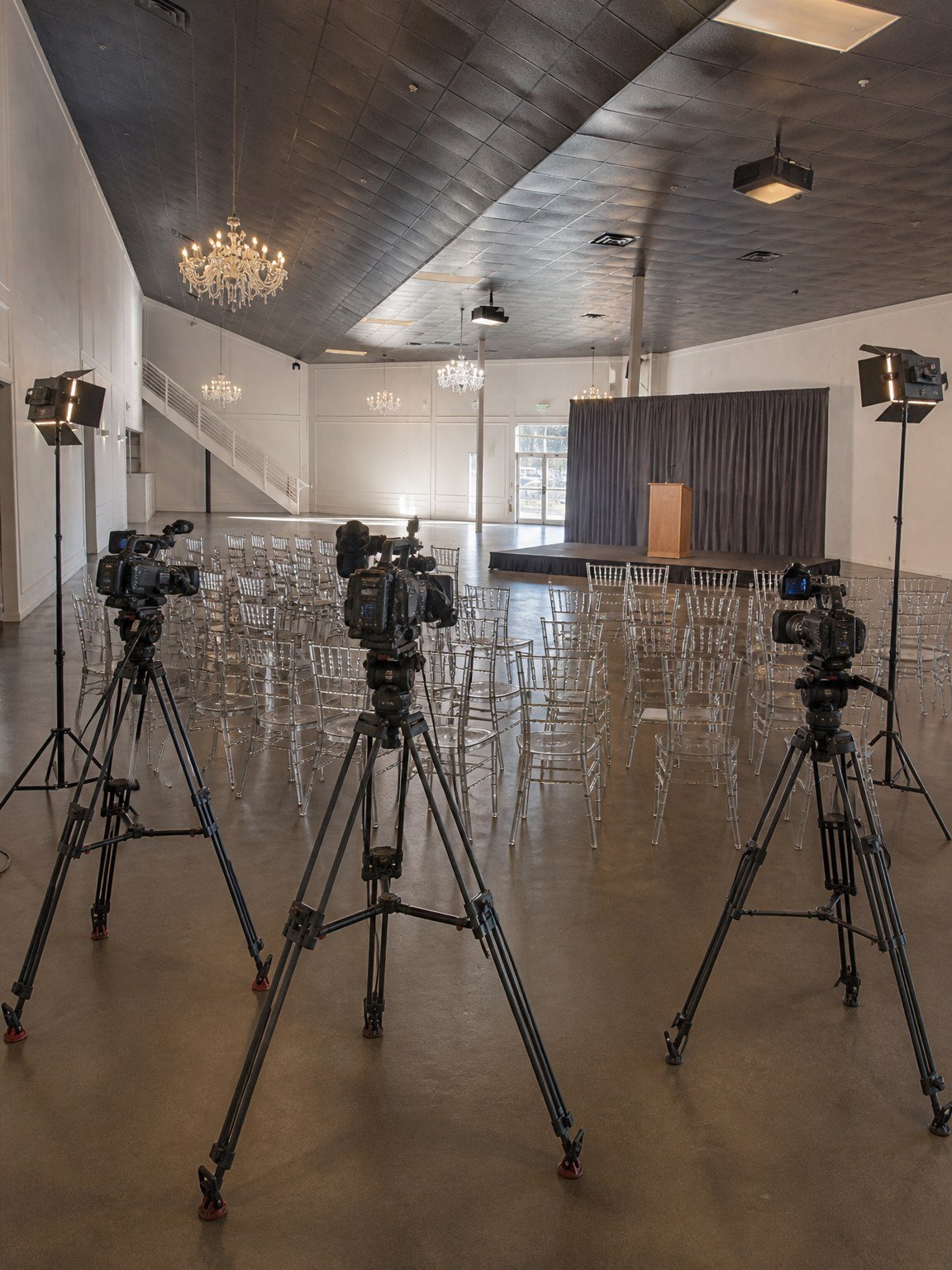 Press and media area at The Hendrix with broadcast cameras facing a lectern
