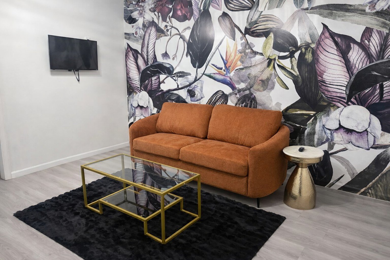 The getting-ready suite at The Hendrix with a floral mural wall and gold table