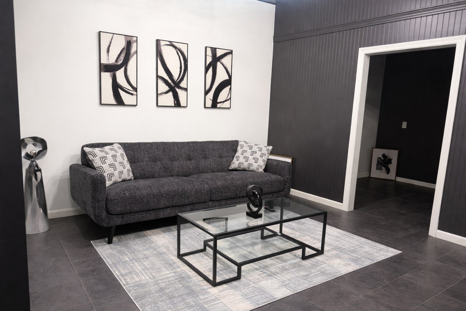 The second suite at The Hendrix with a grey sofa and full-length mirror