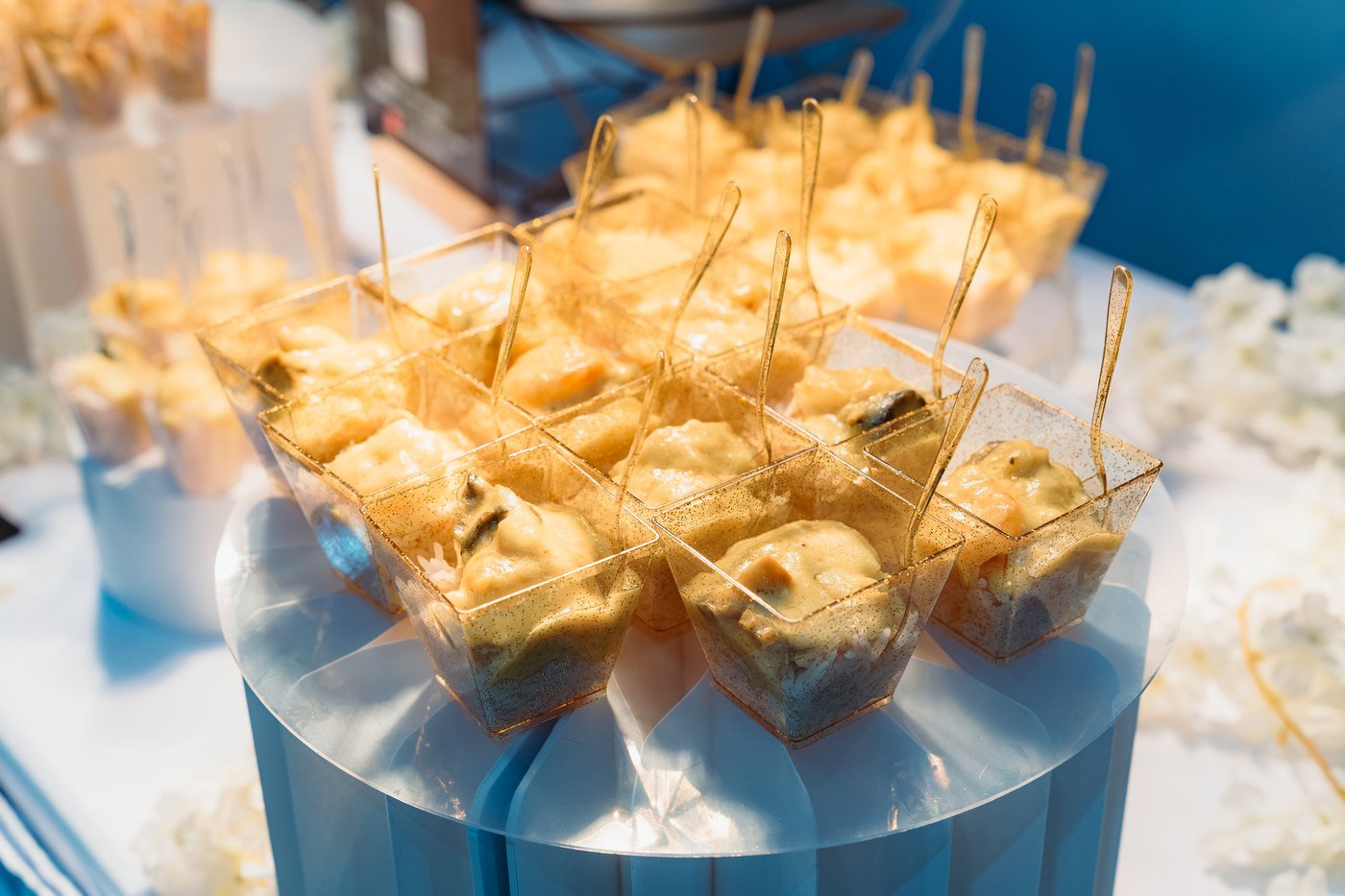 Gold skewered canapes on a tiered stand at a caterer's stand at The Hendrix